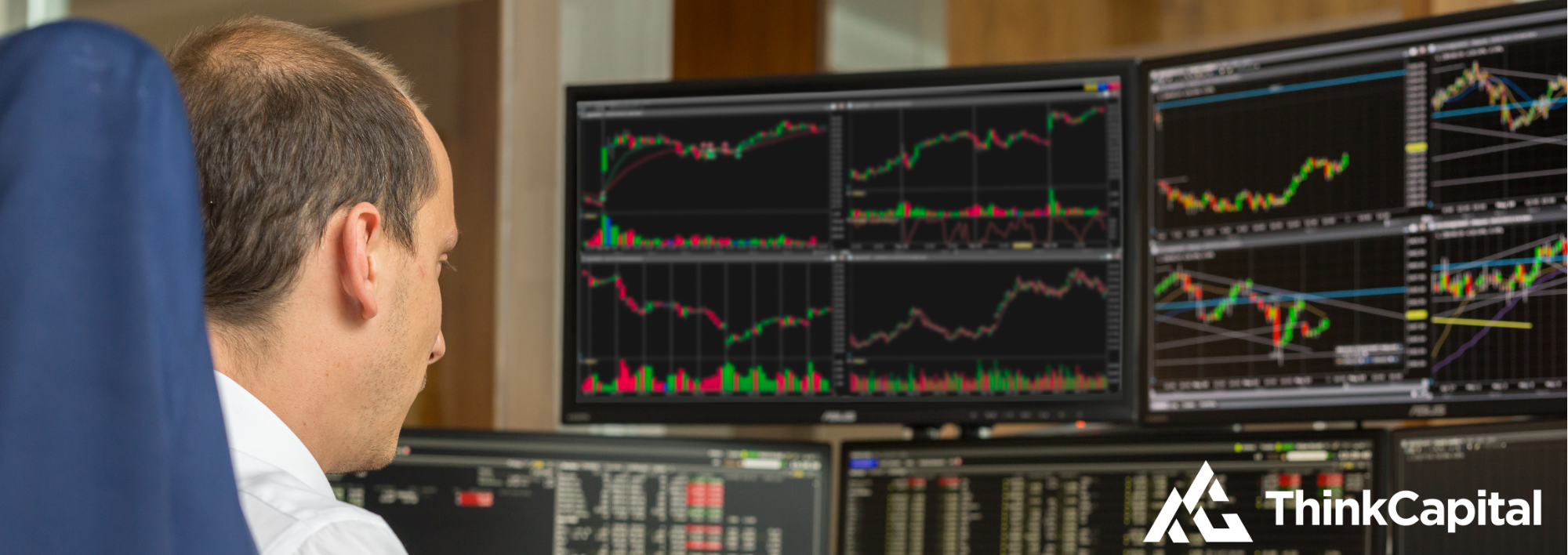 trader looking at multiple chart screens